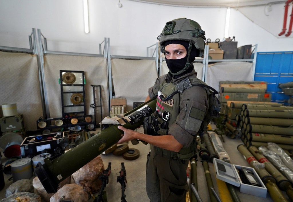 Un militar Israel posa junto a material militar requisado a Hezbolá en sus operaciones militares en el Líbano