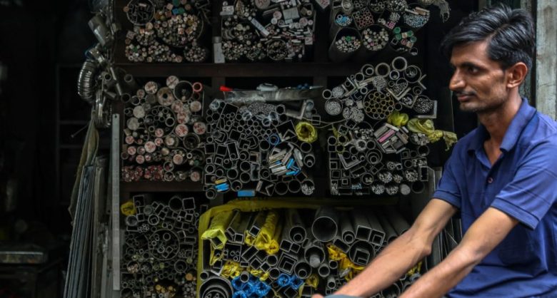 Personas trabajan en un taller al borde de la carretera que lleva a Bhayandarm, India. El país ha superado a Japón y ahora es la cuarta economía más grande