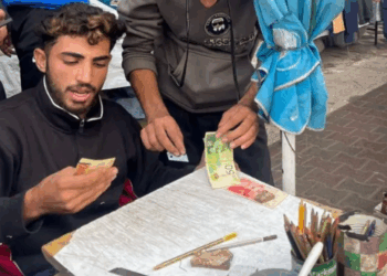 Escasez de Dinero en Gaza Impulsa el Auge de un Nuevo Negocio: la Reparación de Billetes